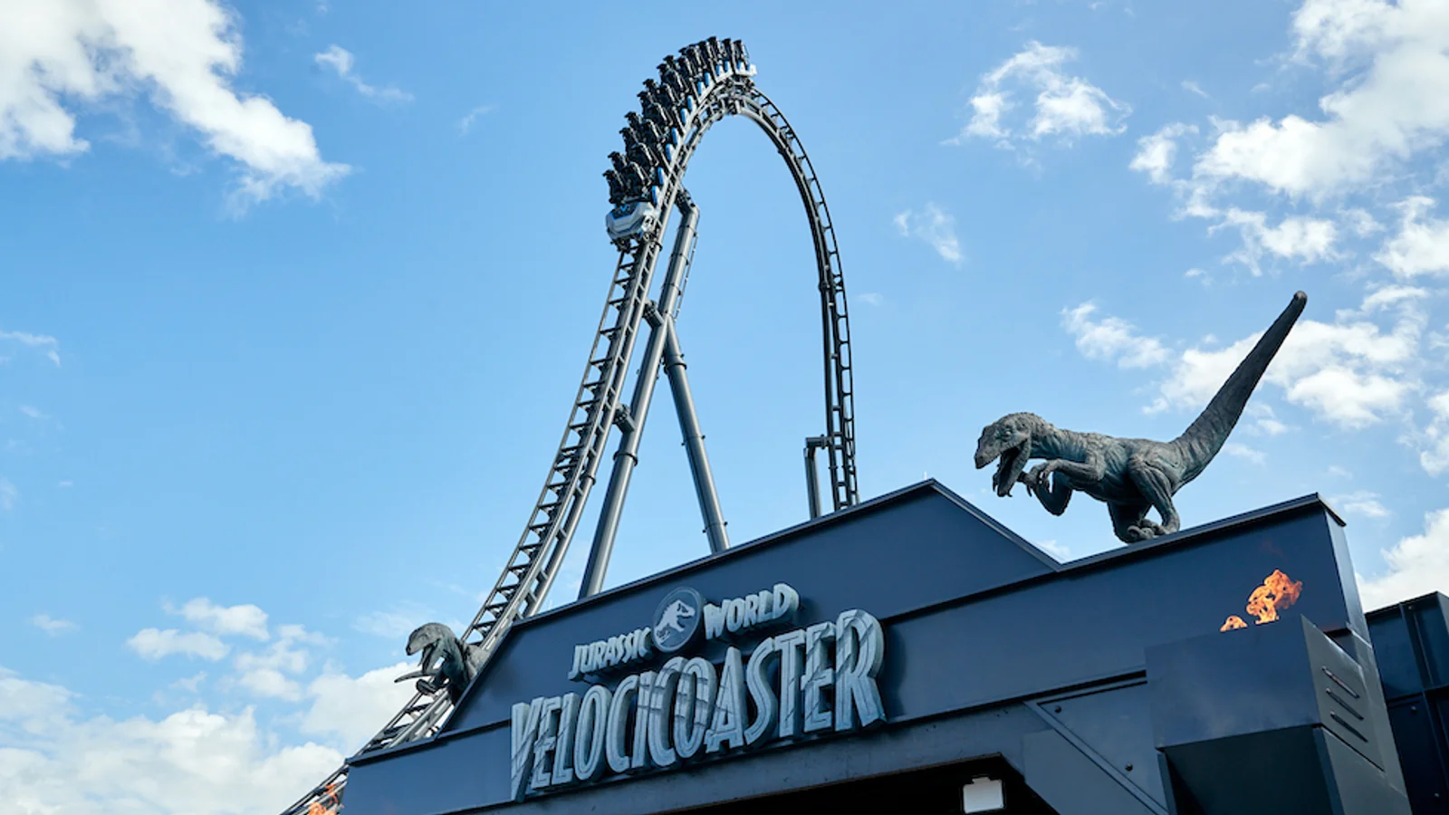 Jurassic World VelociCoaster queue at Universal Orlando with raptor paddock theming and OLED screens